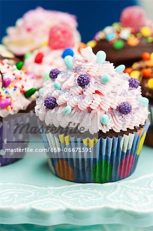 An assortment of ornately decorated cupcakes for a party