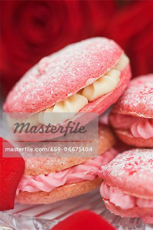 Strawberry and raspberry macaroons with buttercream filling and rose petals