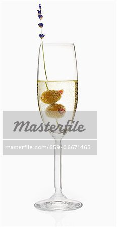 A glass of prosecco with two olives A glass of prosecco with two olives