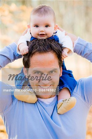 Portrait of Man Carrying Four Month Old Daughter on Shoulders, at Scanlon Creek Conservation Area, near Bradford, Ontario, Canada