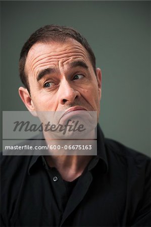 Head and Shoulders Portrait of Mature Man Frowning