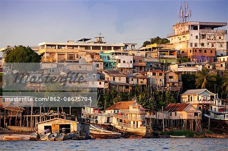 South America, Brazil, Amazonas state, Manaus, stilt houses in a riverside favela, slum community, on the Rio Negro near the industrial docks
