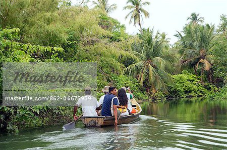 South America, Brazil, Para, Amazon, Marajo island, tourists in wooden canoes visiting red mangrove forest near Soure