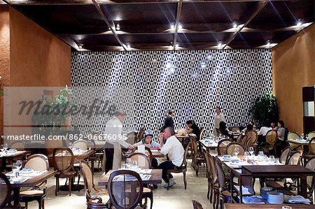 South America, Brazil, Sao Paulo, Alex Attala dining in his award winning Dalva e Dito restaurant in Jardins. The tiles on the back wall were the last work by artist Athos Bulcao