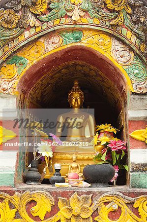 China, Yunnan, Xishuangbanna. A gilded Buddha at the Damenglong Pagodas.