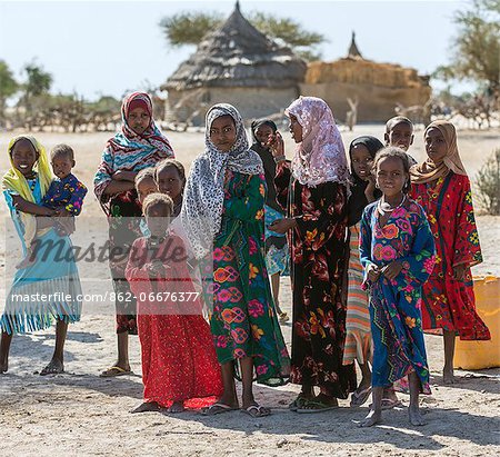Chad, Kanem, Bahr el Ghazal, Sahel. Kreda girls and boys congregate at the water pump outside their village.