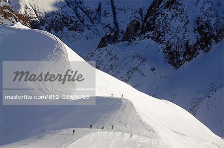 Europe, France, French Alps, Haute-Savoie, Chamonix, Aiguille du Midi, skiers on the Vallee Blanche off piste ridge