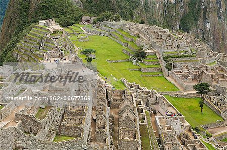 South America, Peru, Cusco, Machu Picchu. A general view of terraces and buildings at the World Heritage listed Inka Historic Sanctuary of Machu Picchu in the Andes above the Urubamba valley South America, Peru, Cusco, Machu Picchu. A general view of terraces and buildings at the World Heritage listed Inka Historic Sanctuary of Machu Picchu in the Andes above the Urubamba valley