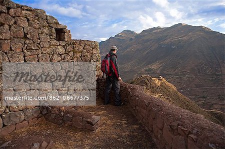 South America, Peru, Cusco, Sacred Valley, Pisac. A hiker looks out over the Sacred Valley from the Inca ruins of Pisac