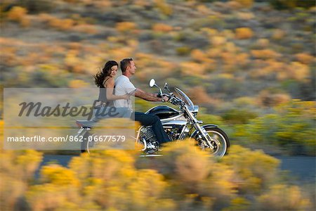 Couple riding a Harley on Highway 20, Bend, Deschutes County, Oregon, USA