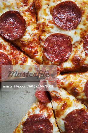 Overhead View of Sliced Pepperoni Pizza in Box, One Slice Missing Overhead View of Sliced Pepperoni Pizza in Box, One Slice Missing