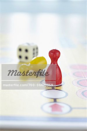 close-up of ludo board game with colored playing pieces and dice