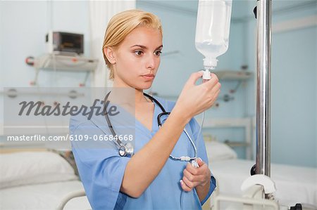 Nurse checking an intravenous drip