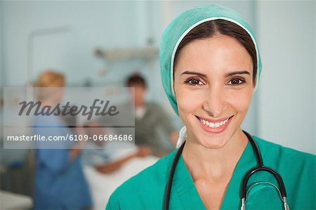 Nurse smiling next to a medical bed