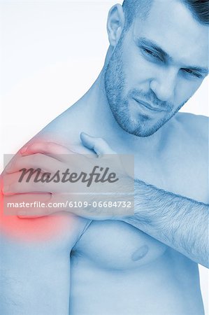Man touching painful highlighted shoulder