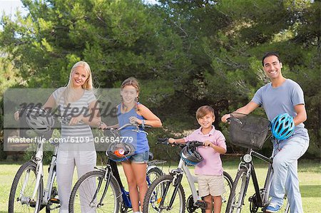 Portrait of smiling family with bikes