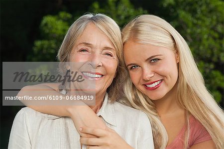 Mother and adult daughter hugging portrait