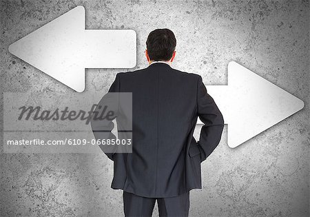 Businessman choosing which direction to go
