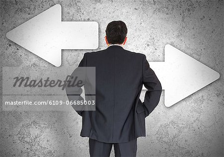 Businessman choosing which direction to go Businessman choosing which direction to go