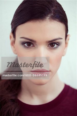 Close-up Portrait of Young Woman Looking at Camera, Studio Shot on White Background