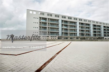 Man in Courtyard of Modern Building on Cloudy Overcast Day, Ostia Lido, Rome, Lazio, Italy