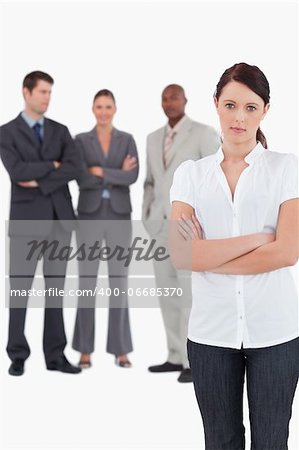 Tradeswoman with arms folded and three colleagues behind her against a white background