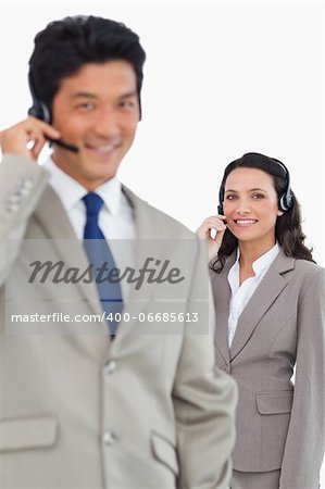 Smiling customer support employees against a white background