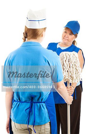 Teenage worker getting handed the mop by her store manager.  Isolated on white.