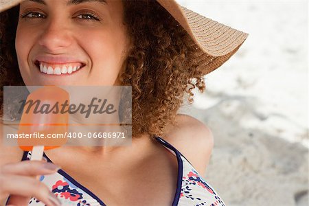 Young attractive woman going to eat a delicious ice cream on the beach