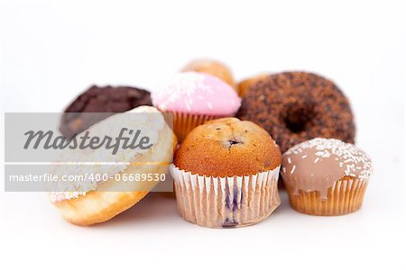 Many cakes laid out together against a white background
