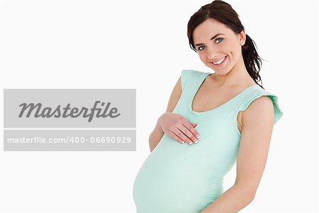 Pregnant woman smiling against white background