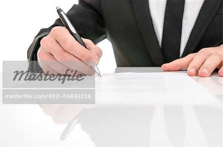 Front view of a business man signing a contract. With reflection on a white table.