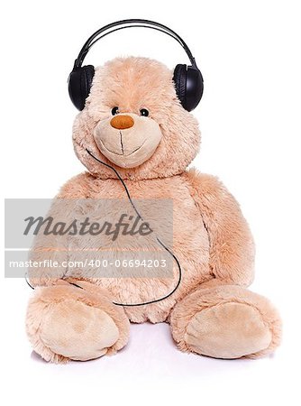 Teddy bear sitting with headset over white background