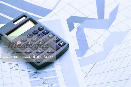 Business concept. Calculator on paper background with business chart