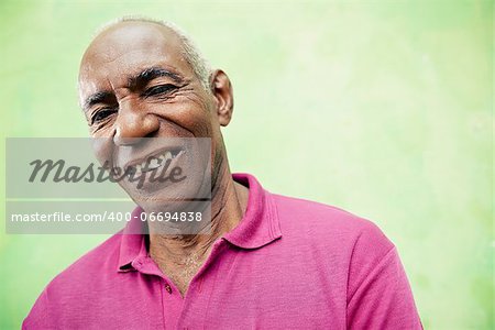 Old people and emotions, portrait of senior african american man looking and smiling at camera. Copy space