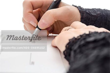 Closeup of a businesswoman signing a contract above signature line.