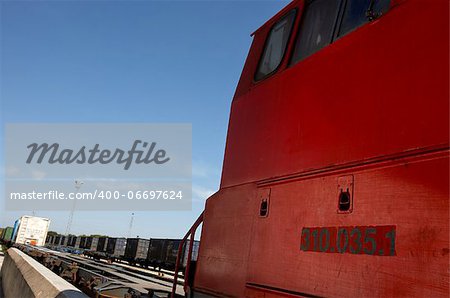 Detail of a red train engine on a railway station