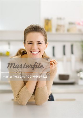 Portrait of smiling young woman in modern kitchen