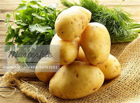 fresh organic potatoes on a wooden table