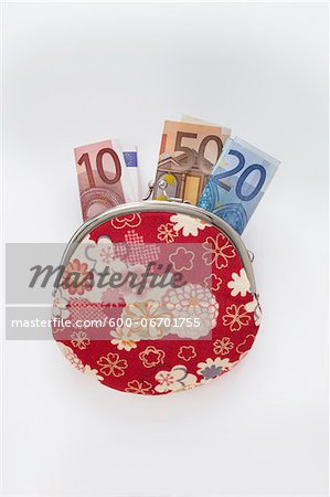 Close-up of Floral Patterned Change Purse with Euro Notes Sticking Out, Studio Shot on White Background