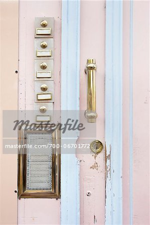 Close-up of pink wooden door with row of bells and door handle, Arcachon, Gironde, Aquitaine, France