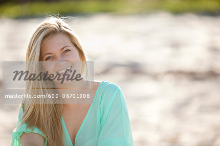 Close-up Portrait of Young Woman on Beach, Looking at Camera and Smiling, Palm Beach Gardens, Palm Beach County, Florida, USA