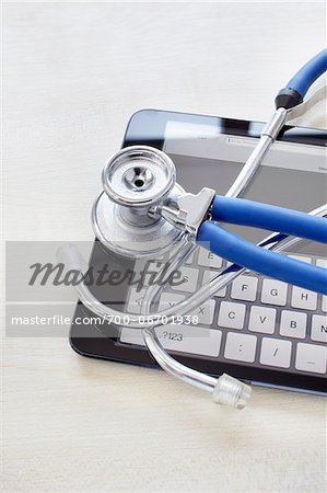 still life of a tablet pc and stethoscope