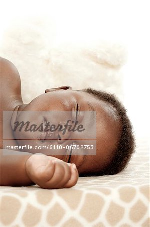 An infant sleeping on a blanket, headshot