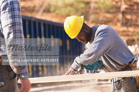 Carpenter using a circular saw to make bevel cut