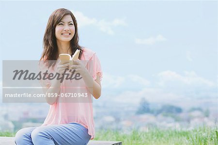 Japanese woman with a book smiling