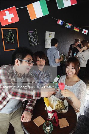 Young people having a drink in a bar