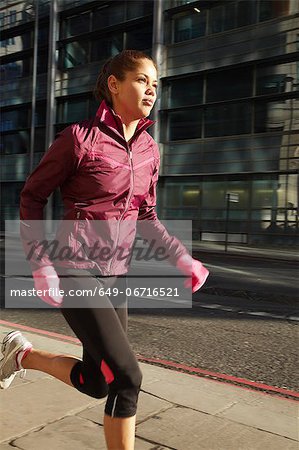 Woman running on city street