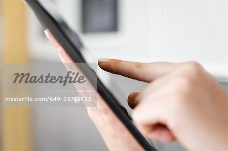 Close up of woman using tablet computer