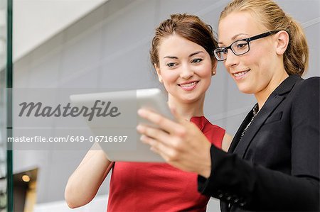Businesswomen using tablet computer